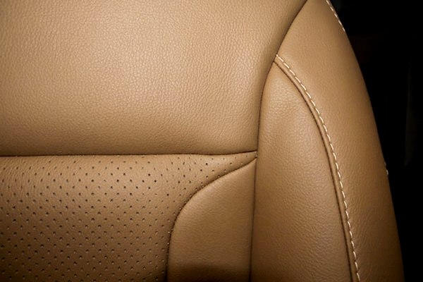 Perforated tan leather car seat with contrast stitching